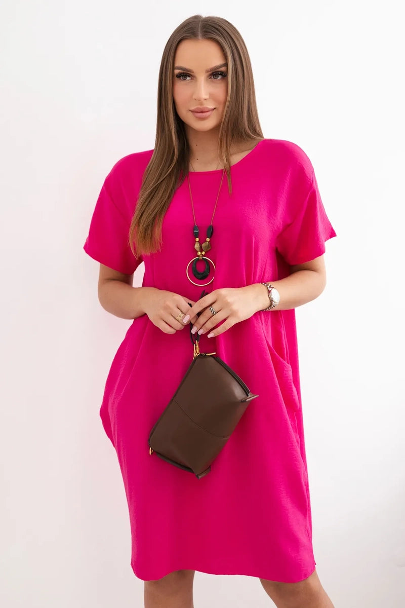 Dress with pockets and pendant